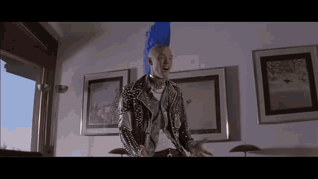 a man with a blue mohawk and studded leather jacket
