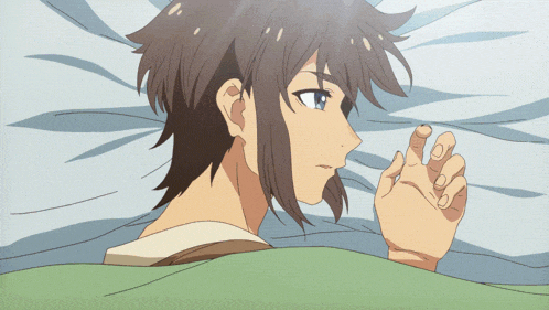 a person laying on a bed with their hand on their face