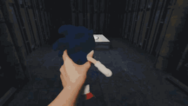 a stuffed toy of sonic the hedgehog is standing in front of a white box