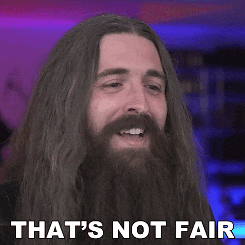 a man with long hair and a beard has the words that 's not fair on his face