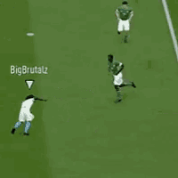 a soccer game is being played on a green field