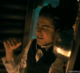 a man in a tuxedo is talking on a cell phone and says hello