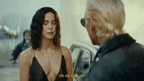 a woman in a black dress is talking to a man in a car who is saying oh my god no