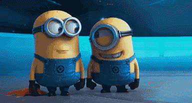 two minions standing next to each other with one wearing overalls and goggles