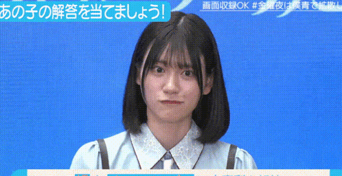 a girl in a blue shirt making a funny face