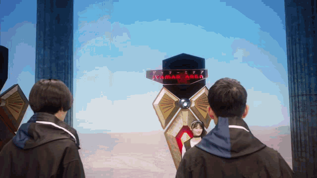 two men are looking at a display that says kamal area