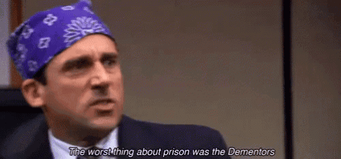 michael scott is wearing a purple bandana on his head and talking about prison .