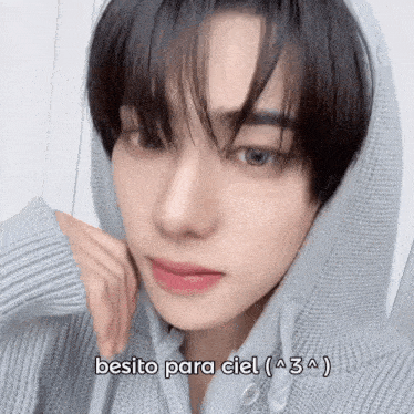 a close up of a person wearing a sweater with the words besito para ciel written on the bottom