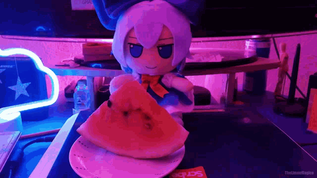 a stuffed animal is eating a slice of watermelon on a plate