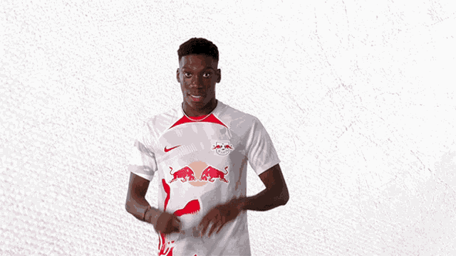 a man in a white shirt with a red bull on it