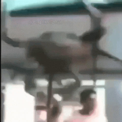 a blurry picture of a person standing on a balcony with a helicopter in the background .
