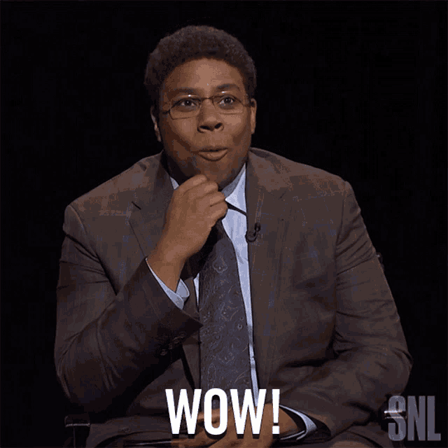 a man in a suit and tie says wow in a snl ad