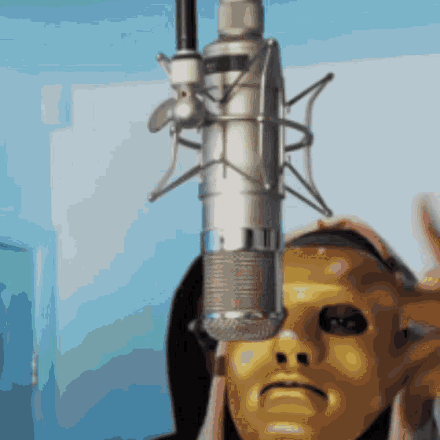 a microphone is hanging from the ceiling in front of a masked person