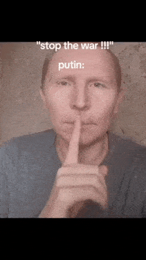 a man holds his finger to his lips and says " stop the war putin "