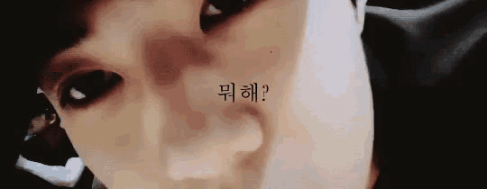 a close up of a person 's face with a foreign language tattoo on it .