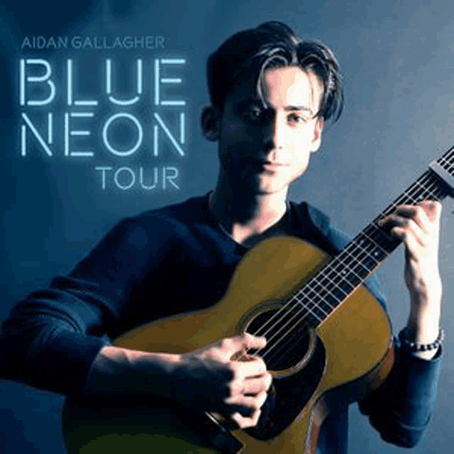 a young man is holding a guitar in his hands on the cover of a blue neon tour album .
