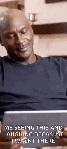 michael jordan is sitting on a couch laughing because he wasn 't there .