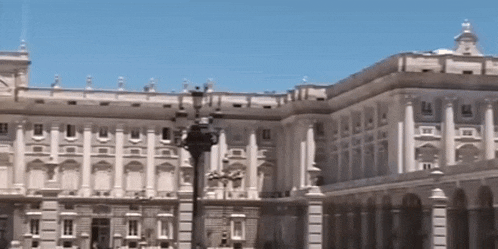 a large white building with columns and a street light in front of it