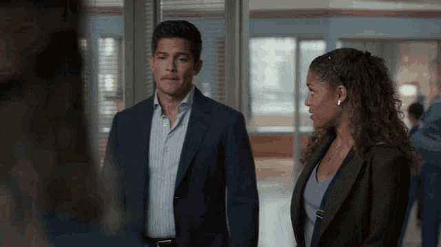 a man and a woman are standing next to each other