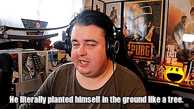 a man wearing headphones with the words " he literally planted himself in the ground like a tree " next to him