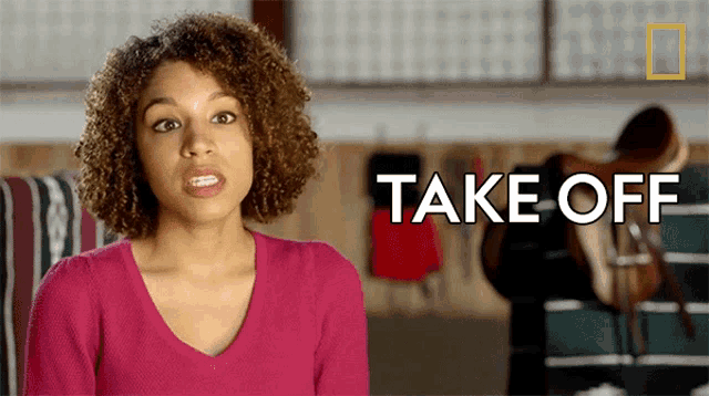 a woman with curly hair says take off in front of a saddle