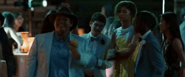 a group of people are dancing together at a party .