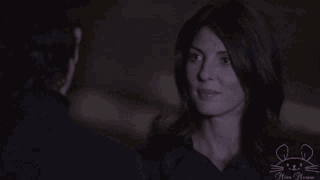 a man and woman are looking at each other and the woman is named sophie devereaux grifter
