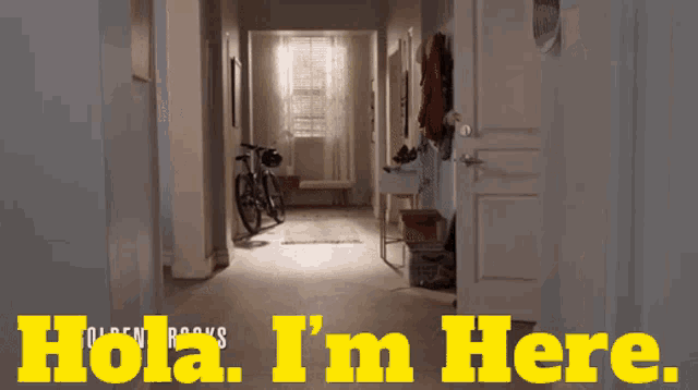 a woman standing in a hallway with the words hola i 'm here written in yellow