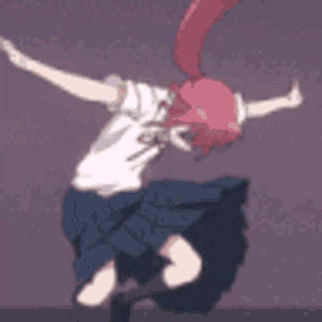 a girl in a school uniform is dancing in a dark room .