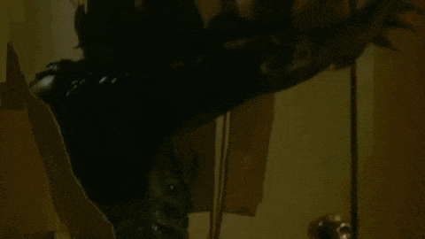 a close up of a person standing in a dark room .