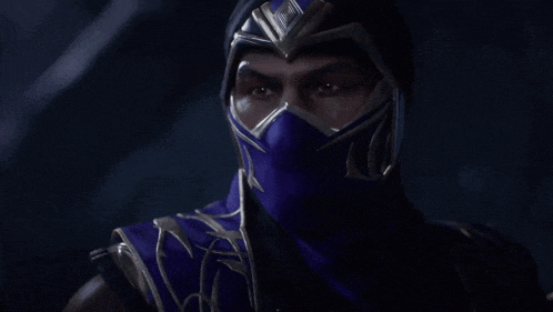 a man wearing a purple mask and a helmet looks at the camera