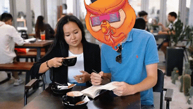 a man with an owl mask on his head sits at a table with a woman