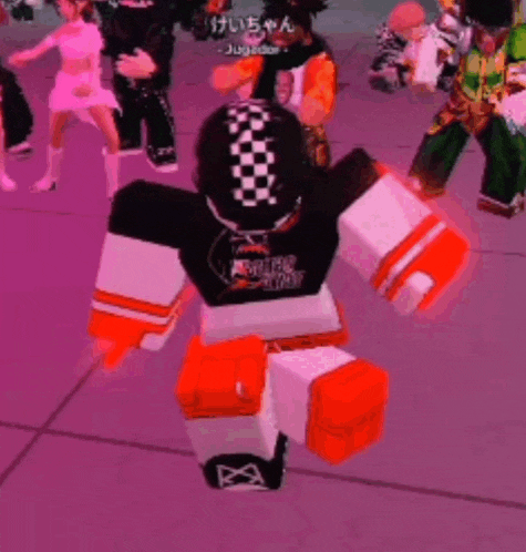 a group of people are playing a video game and one of them is wearing a black and white shirt with orange gloves .
