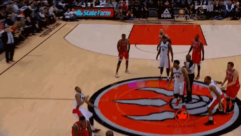 a basketball game is being played on a court with a toronto raptors logo