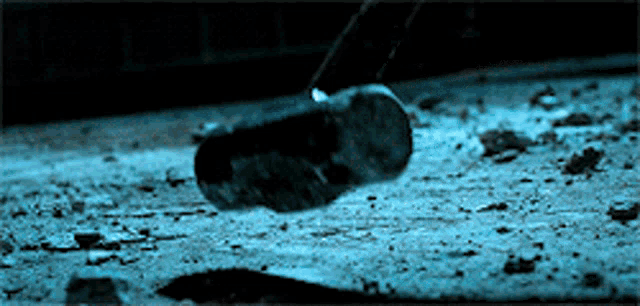a person 's foot is flying through the air on a concrete floor