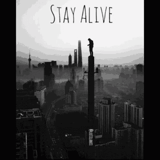 a man is standing on top of a tall building with the words stay alive below him
