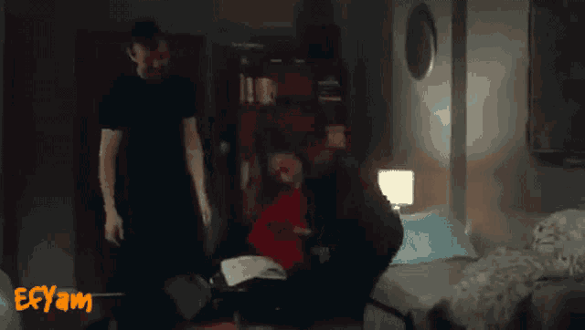 a man and a woman are standing in a room with the word ecyam on the bottom