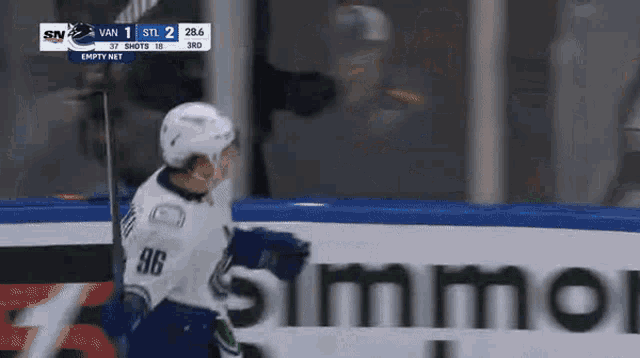a hockey player with the number 86 on his jersey stands in front of an empty net