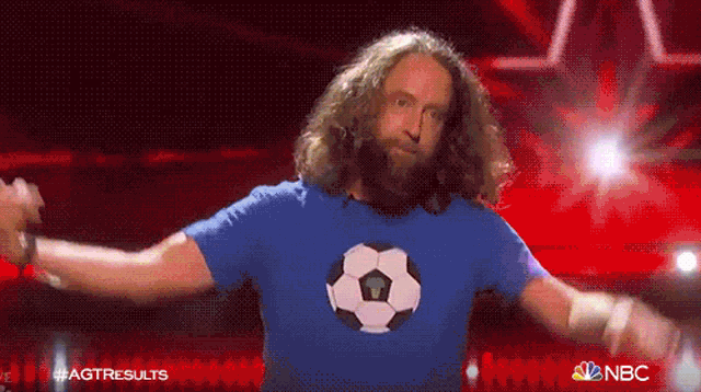 a man in a blue shirt with a soccer ball on it