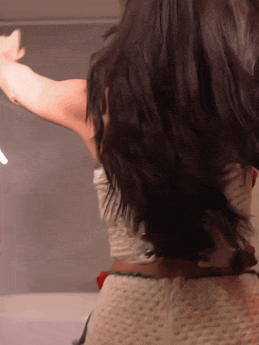 the back of a woman 's hair is shown in a close up