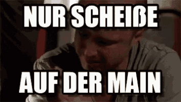 a man is sitting in a chair with a glass of wine in his hand and a caption that says nur scheibe auf der main .