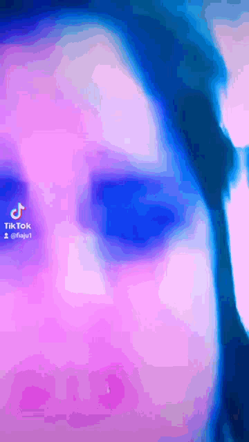 a close up of a person 's face with a tik tok icon in the corner