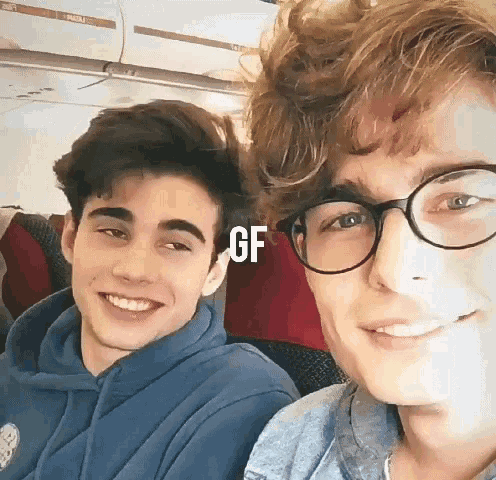 two young men are posing for a picture and the word gf is on the bottom right corner