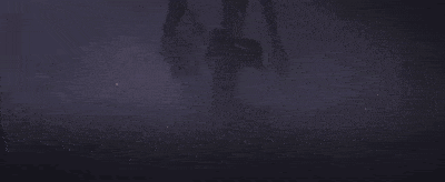 a person is walking in the dark with a blue umbrella .