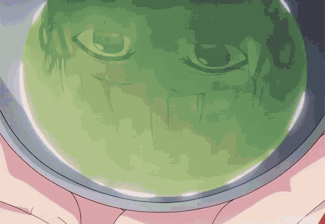 a close up of a person 's face in a green container