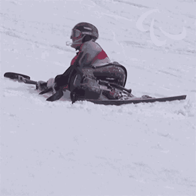 a person in a wheelchair is skiing down a snowy slope