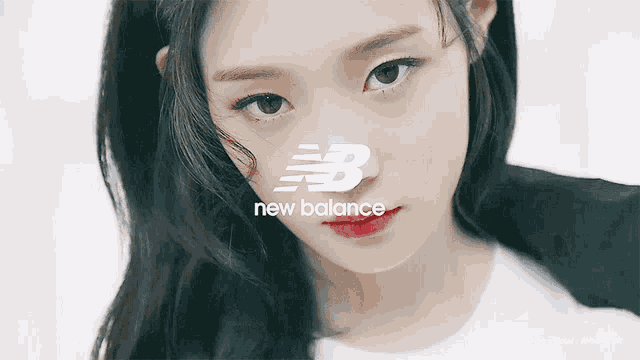 a close up of a woman 's face in front of a new balance logo