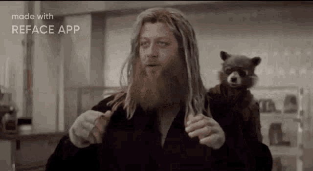 a man with a beard is standing next to a raccoon in a kitchen .