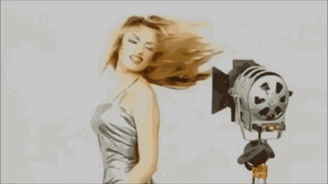 a woman is standing in front of a camera with her mouth open