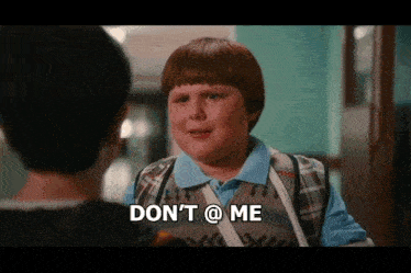 a young boy says " don 't @ me " while talking to another boy